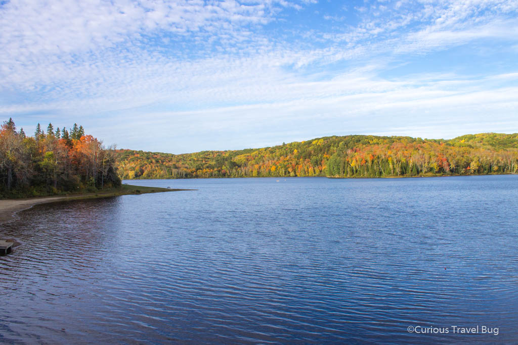 Arrowhead Lake at Arrowhead Provincial Park with the beautiful Huntsville Fall colours with red and gold leaves.